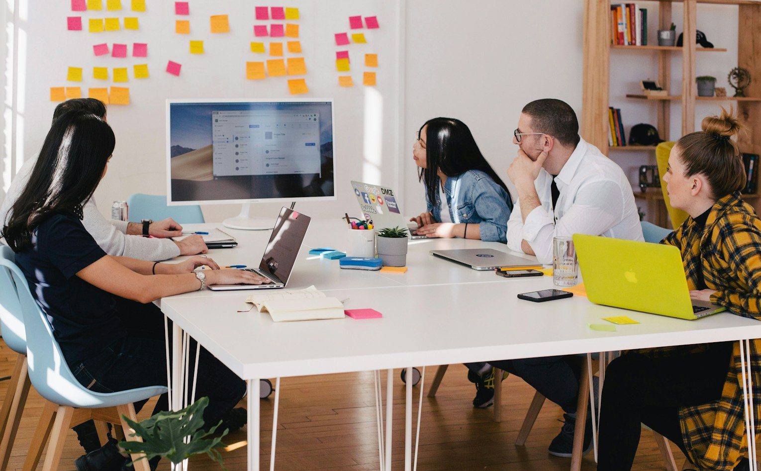 five person by table watching turned on white iMac